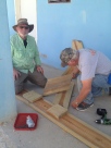 Carl and James work on benches for the church.